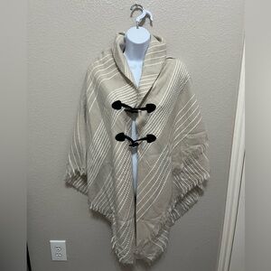 Women’s poncho top, beige with black accents , perfect for cooler weather.